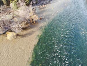 The brown, turgid waters of Hangman Creek meets the Spokane River