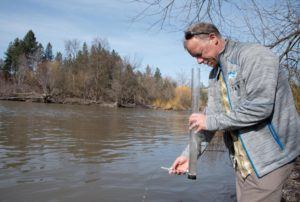 Jerry White, the Spokane Riverkeeper, checks the turbidity of Hangman Creek
